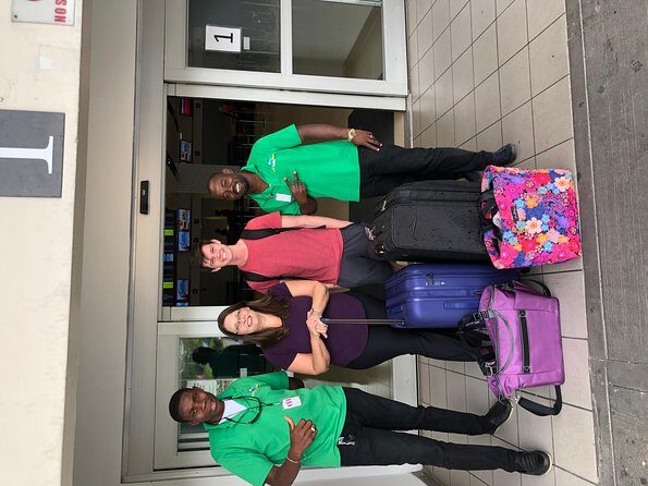 Airport MBJ Round Trip Transfers, to Montego Bay Airbnb & Resorts - Arrival pickup at Sangster Airport: signboard, holding area, luggage