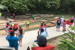 (Martha Brae River) Bamboo Rafting - Reaching the river site: life vest, welcome drink, and a smooth loading flow